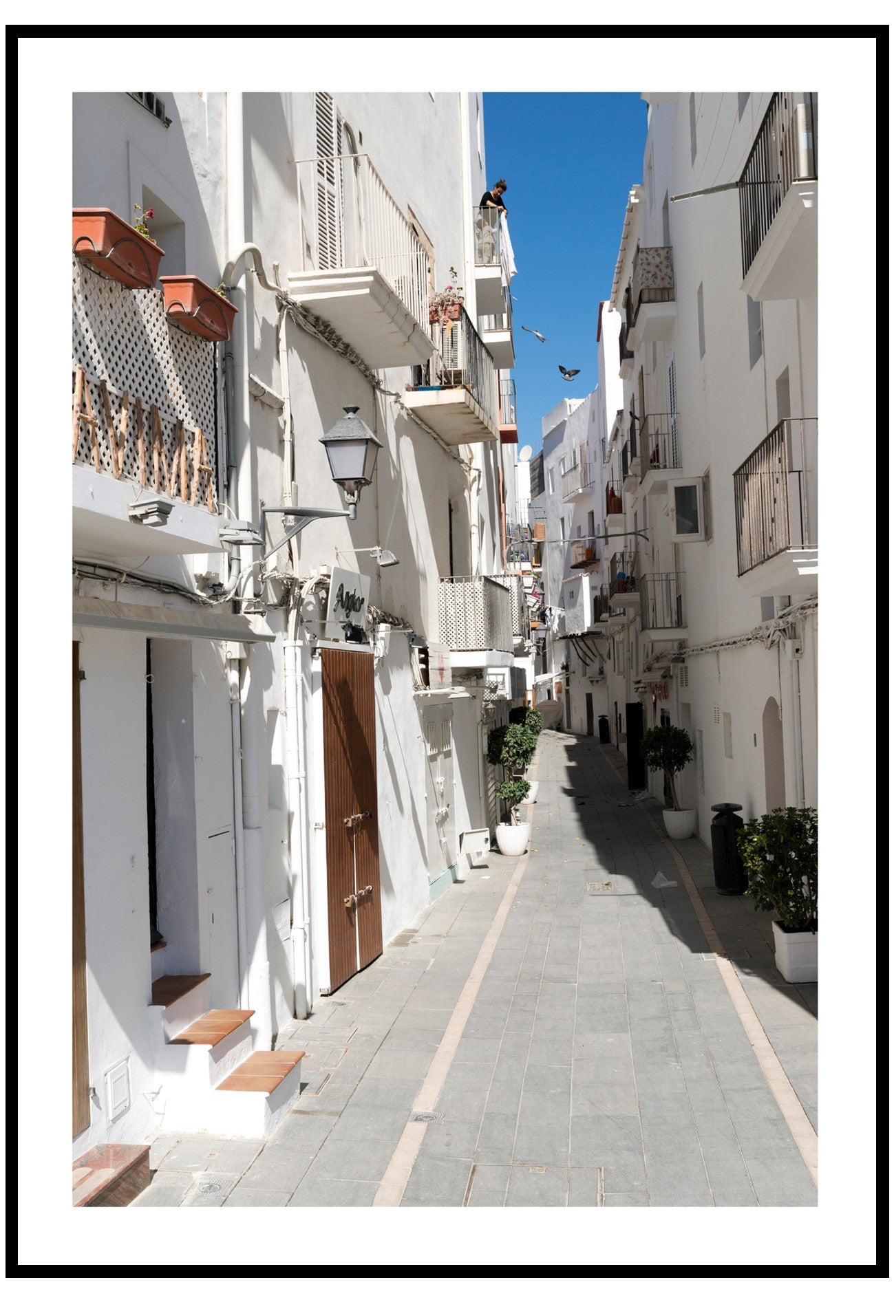  Poster of narrow Ibiza street with white buildings in a Mediterranean town