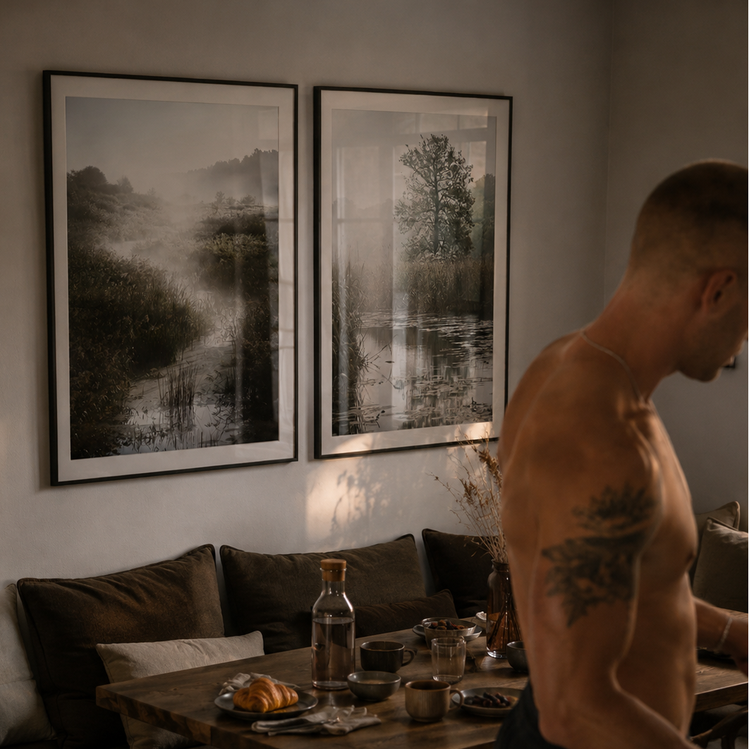 Man cooking in a kitchen with a couch and framed pictures in the background