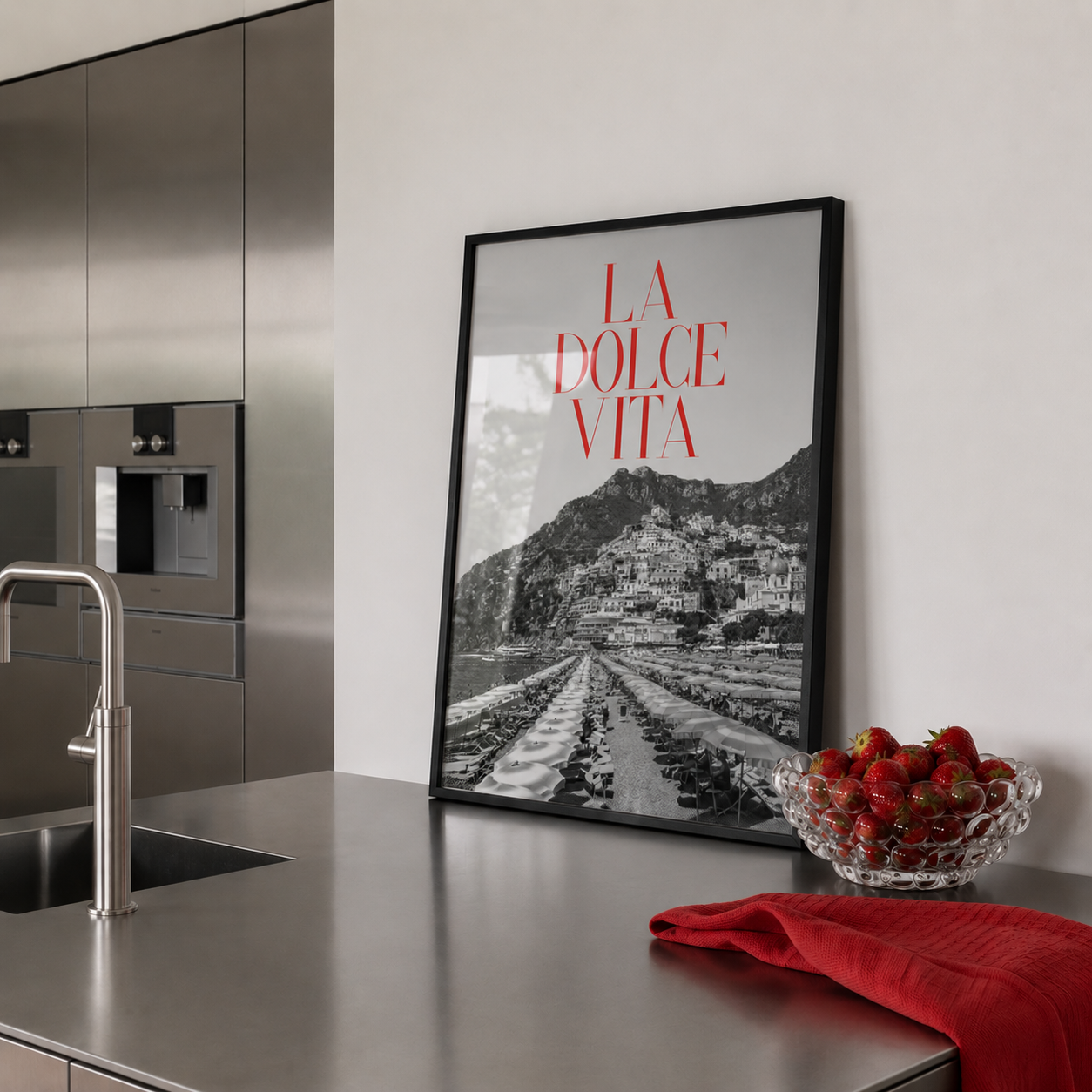 Modern kitchen with 'La Dolce Vita' framed print on the wall.