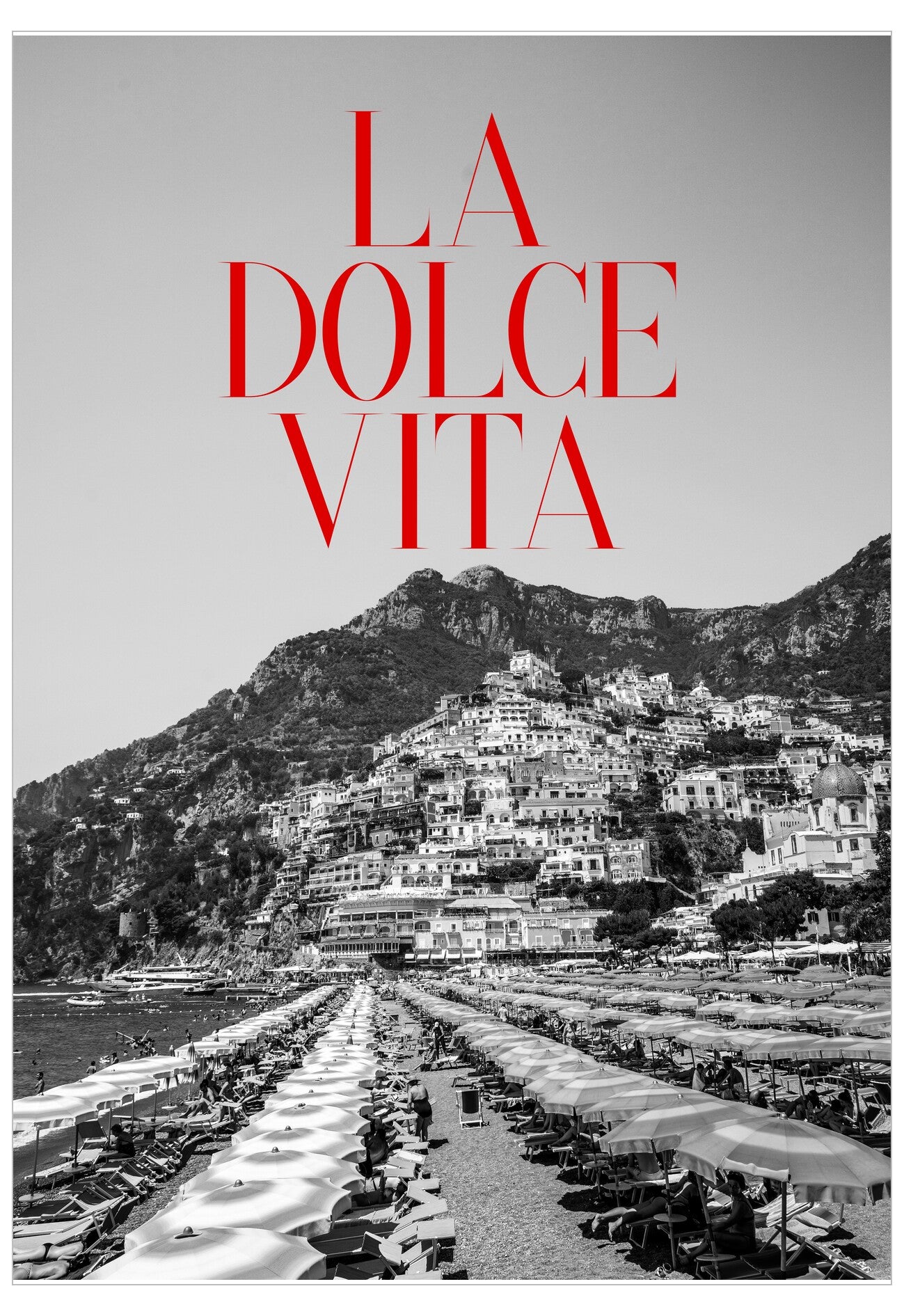 Black and white photo of a coastal town with 'La Dolce Vita' text in red.