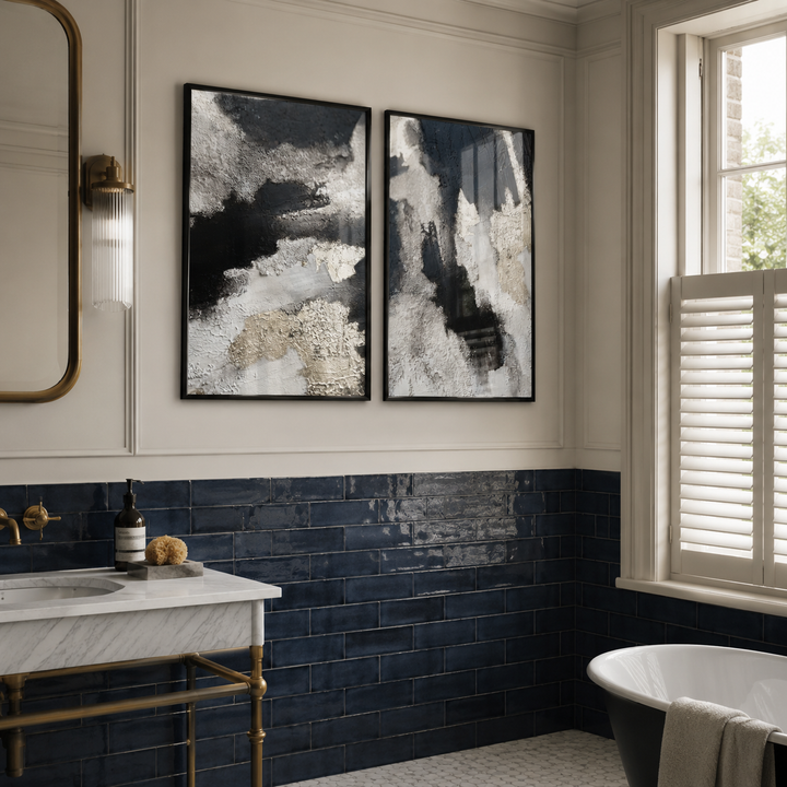 Modern bathroom with abstract art on the wall, dark blue tiles, and a freestanding bathtub.