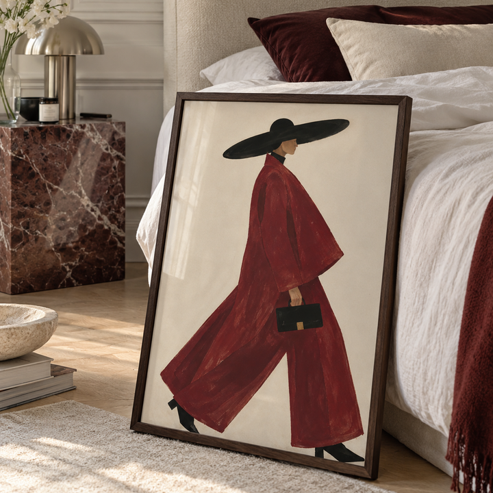 Illustration of a woman in a deep red suit and oversized black hat strides confidently across the frame, embodying Scandinavian luxury through bold minimalism.