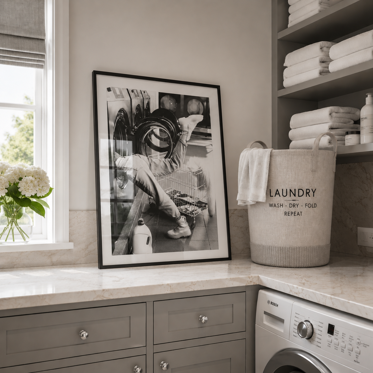 Laundry room with framed picture, laundry basket, and washing machine.