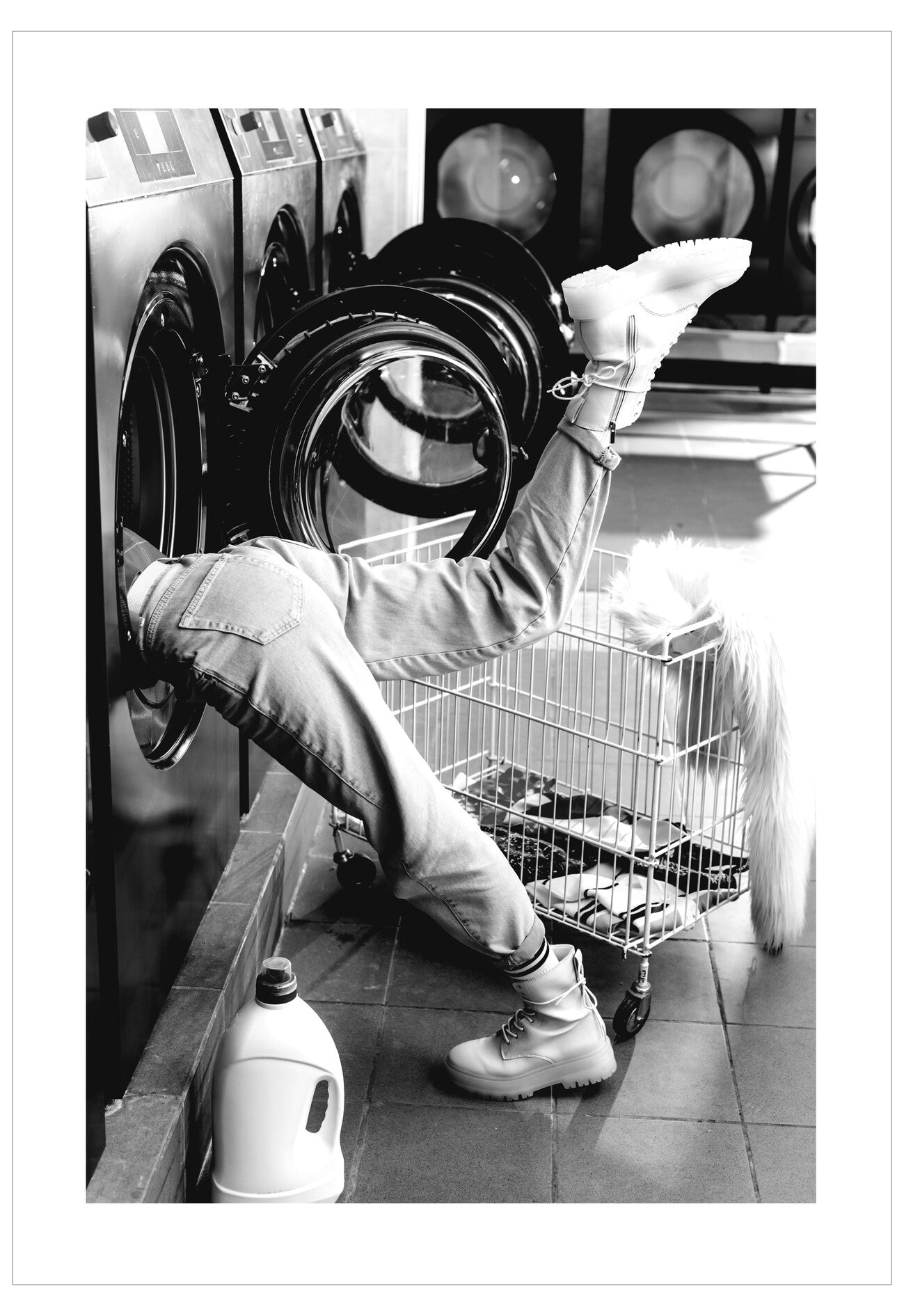 Person loading a washing machine in a laundromat