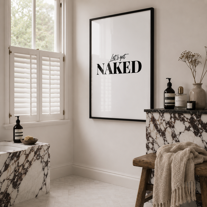 Stylish Marble Modern Bathroom with 'Let's Get Naked' poster on the wall