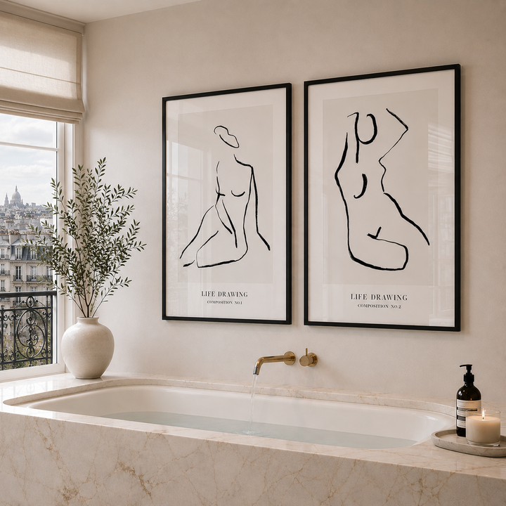 Bathroom interior with abstract art prints on the wall, a vase with plants, and a candle.