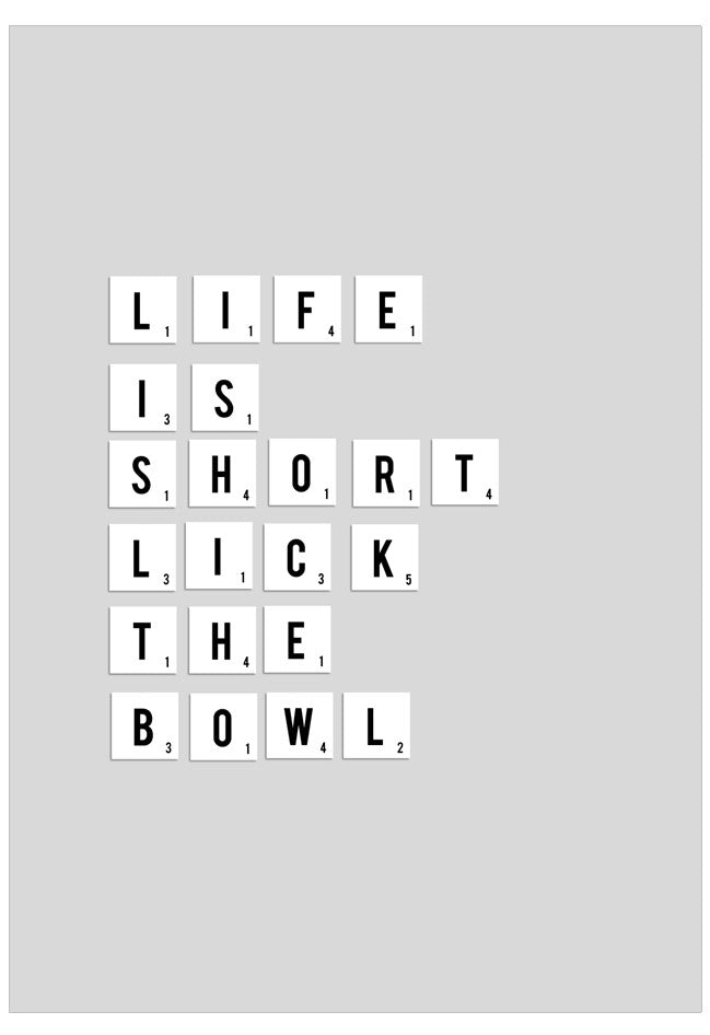 Motivational quote 'Life is short, lick the bowl' on a gray background