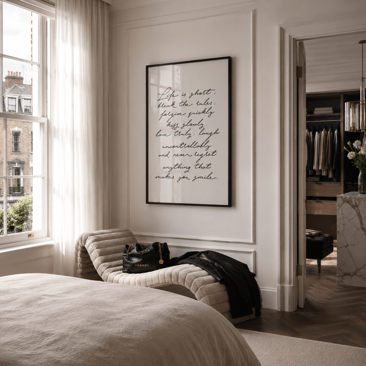 Modern bedroom with a bed, chair, and framed quote on the wall.