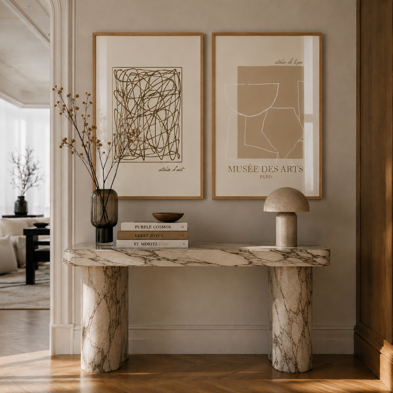 Marble console table with decorative items against a wall with framed art.