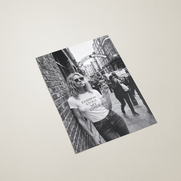 Poster with a black and white photo of a person wearing a 'Fashion is my Religion' t-shirt on a beige background
