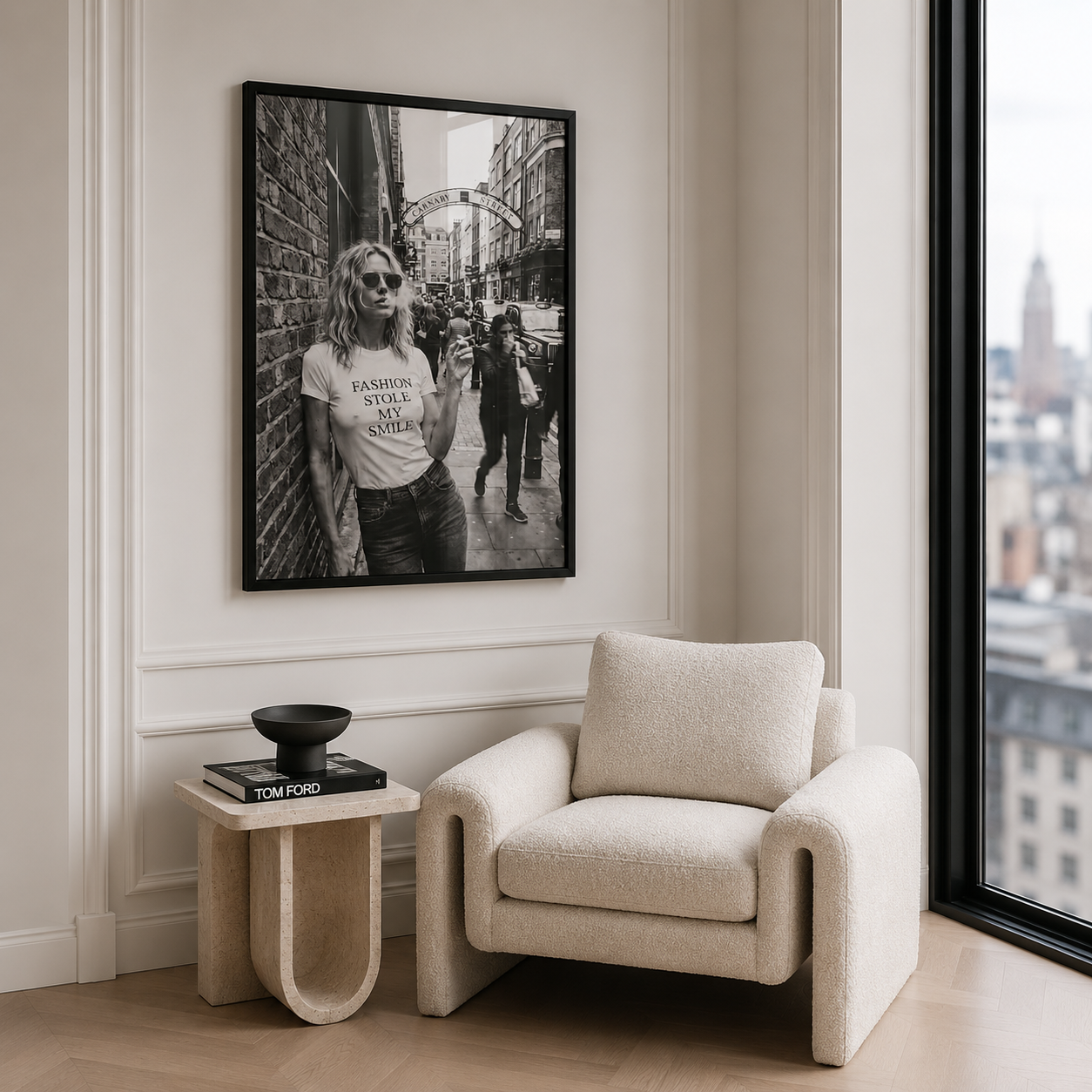 Modern living room with a beige armchair, side table, and framed black and white photo on the wall.