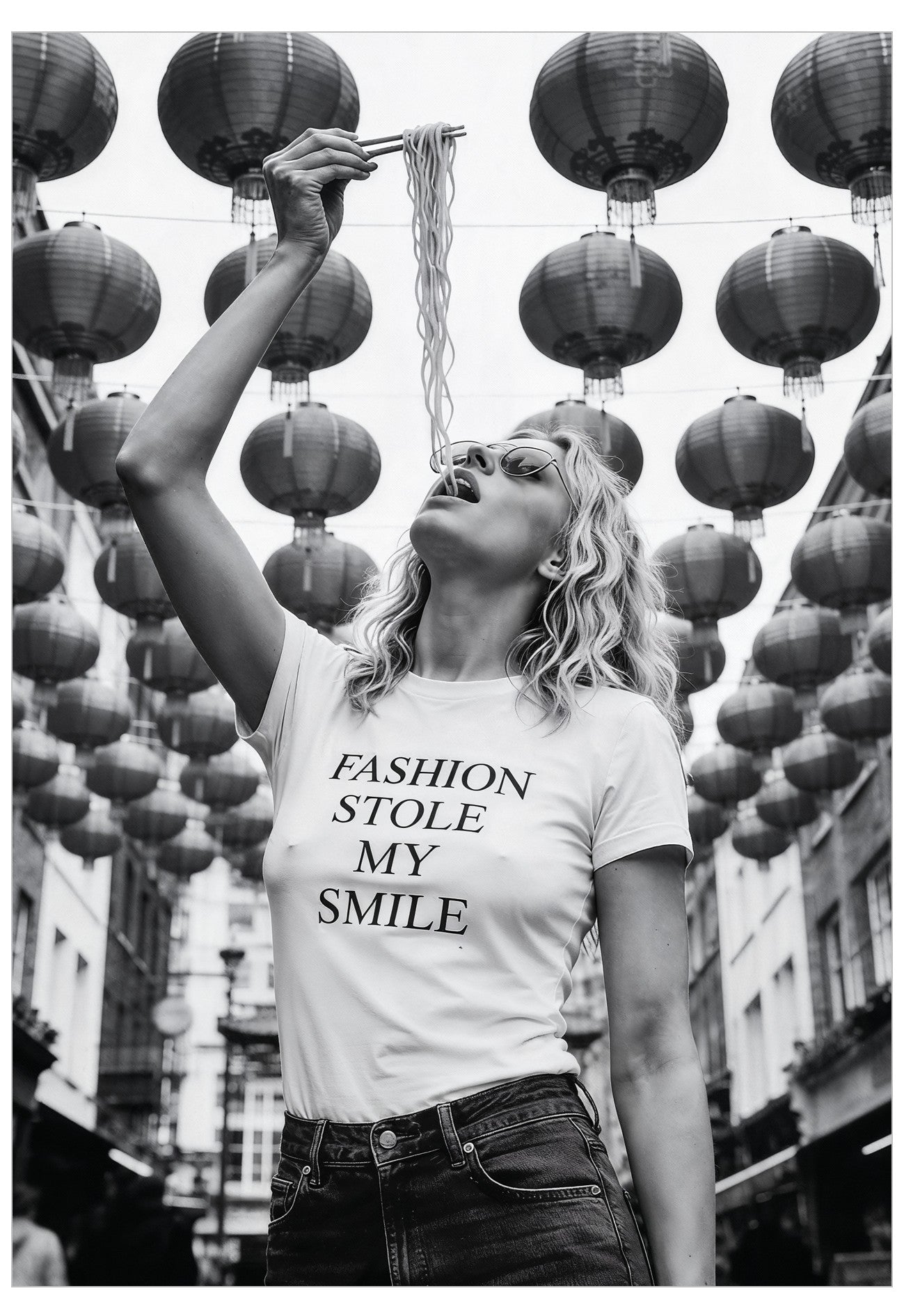Woman eating noodles wearing a t-shirt with 'Fashion stole my smile' text in Chinatown with hanging lanterns.