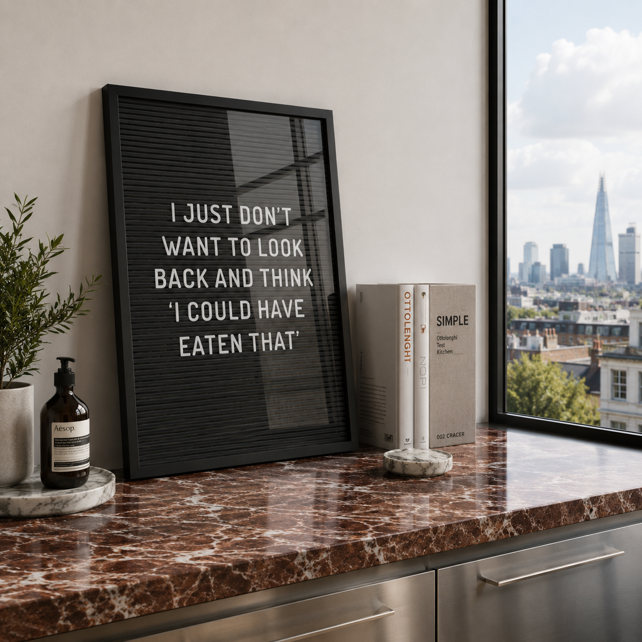 Framed quote on a marble countertop with a cityscape view