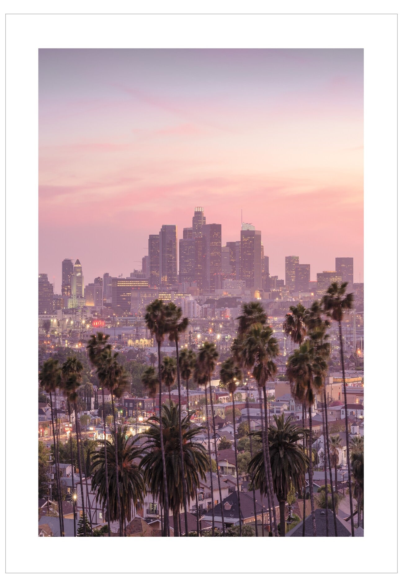City skyline with palm trees at dusk