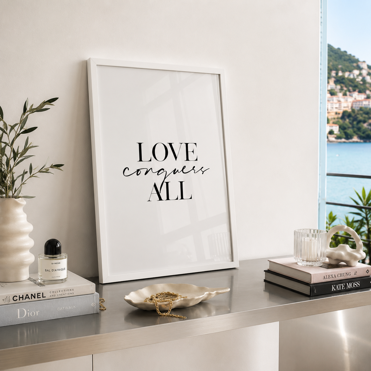 Love conquers all black and white typography wall art in a white wood frame