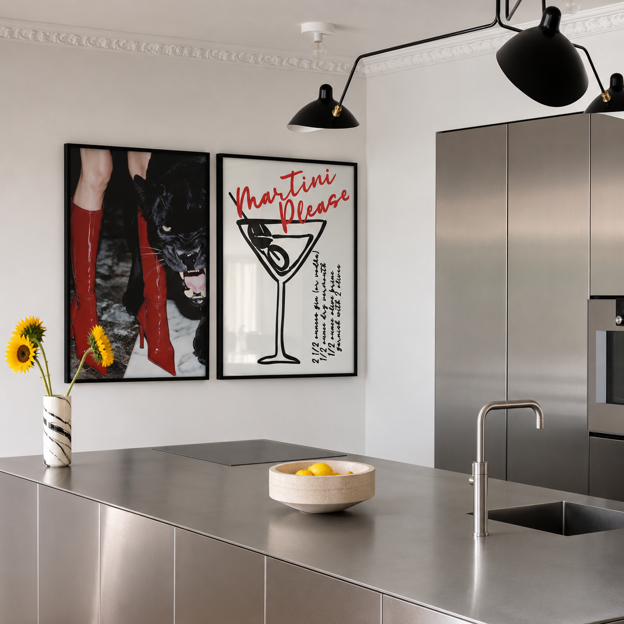 Modern kitchen with metallic island, black pendant light, and wall art.