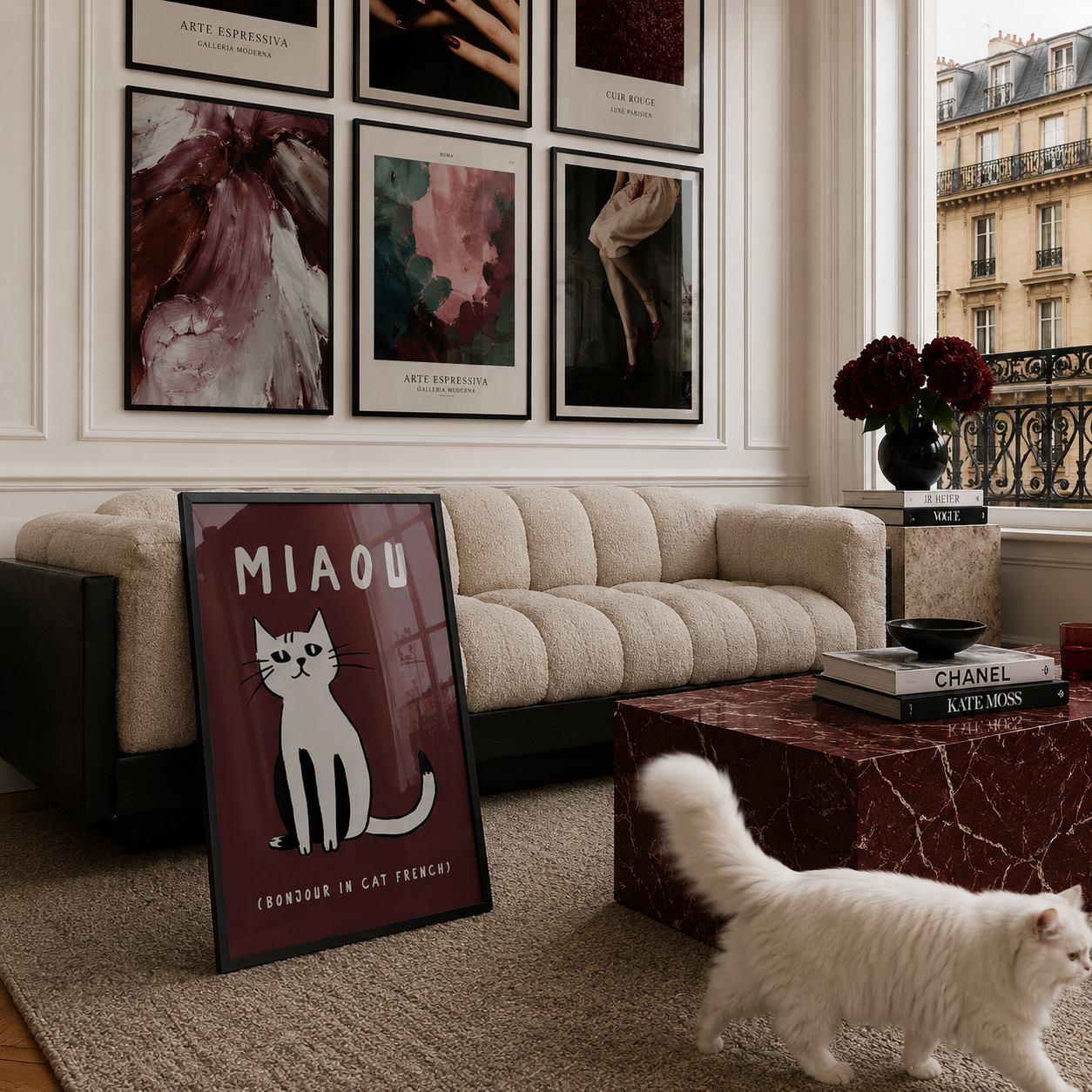Living room with a beige sofa, framed art on the wall, and a cat walking on the floor.