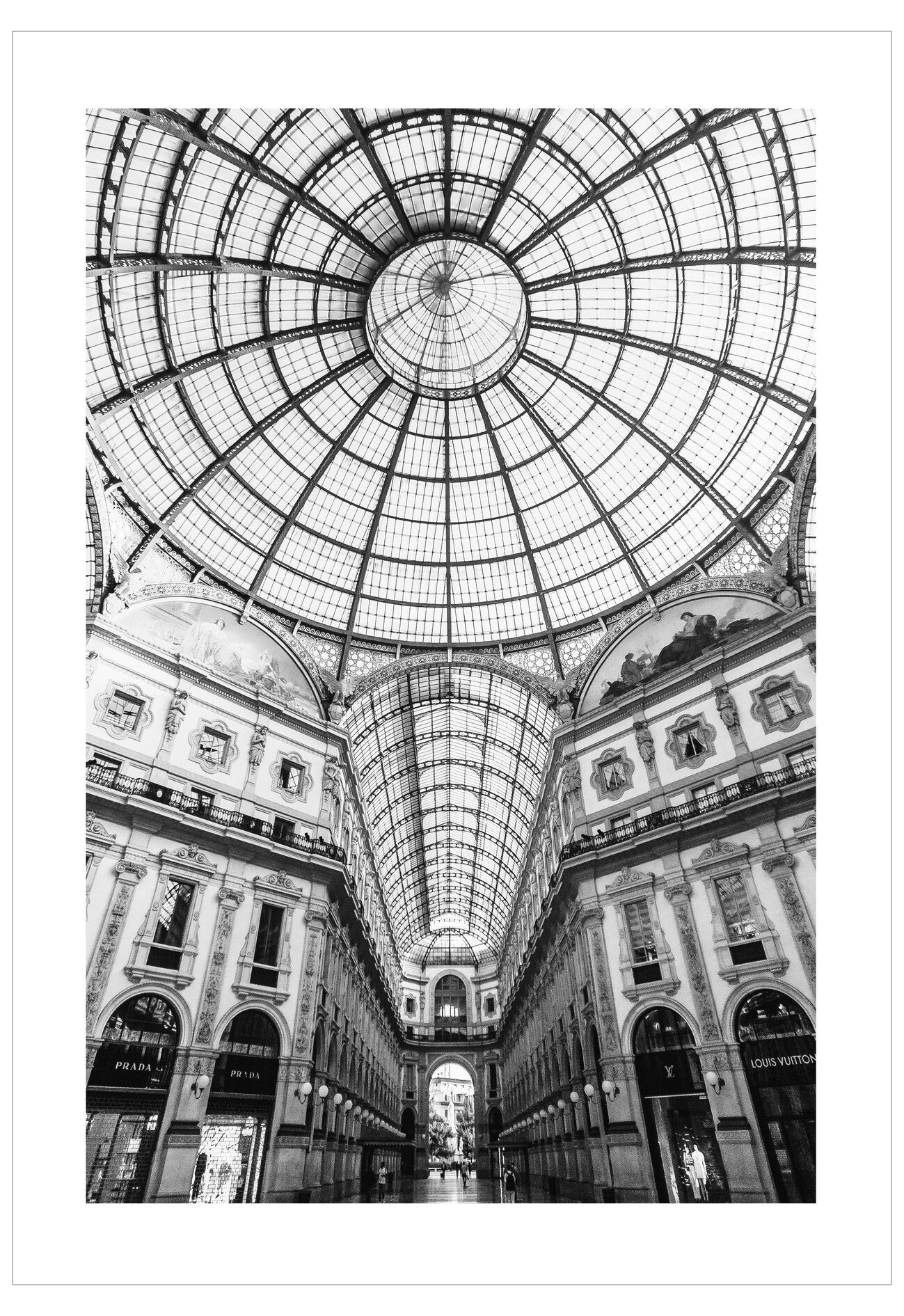 Glass ceiling of a grand architectural interior with classical columns and arches.