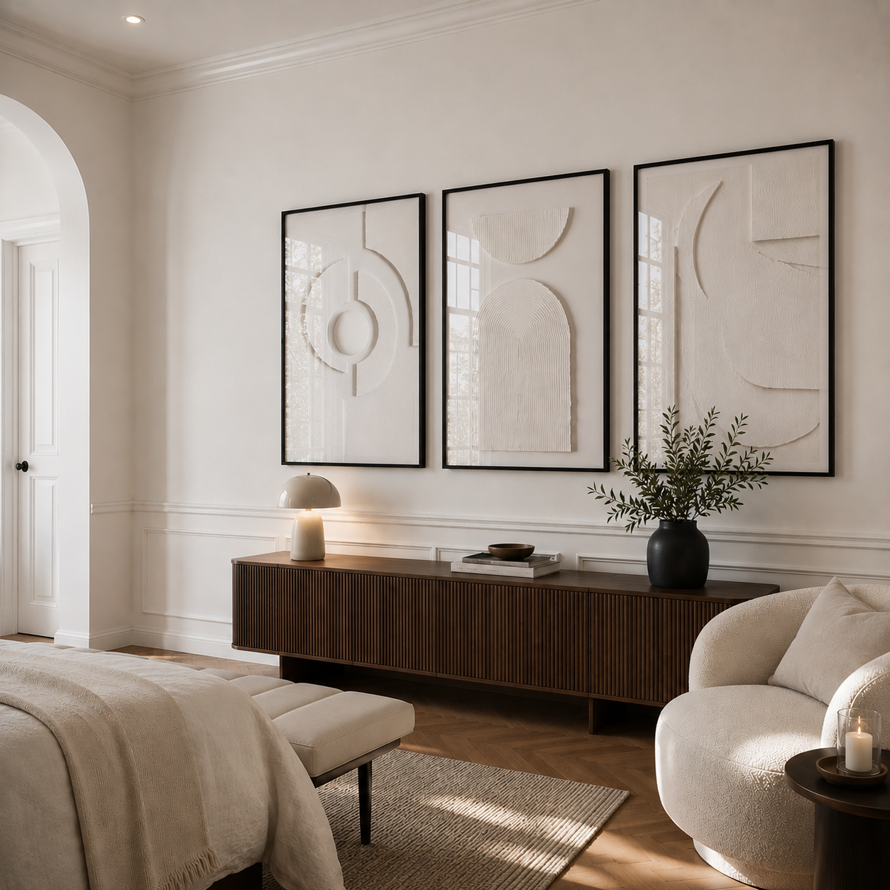 Modern living room with abstract wall art, a wooden console table, and a white armchair.