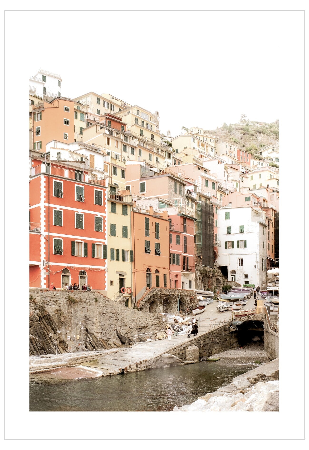 Colorful buildings along a canal in a hilly town