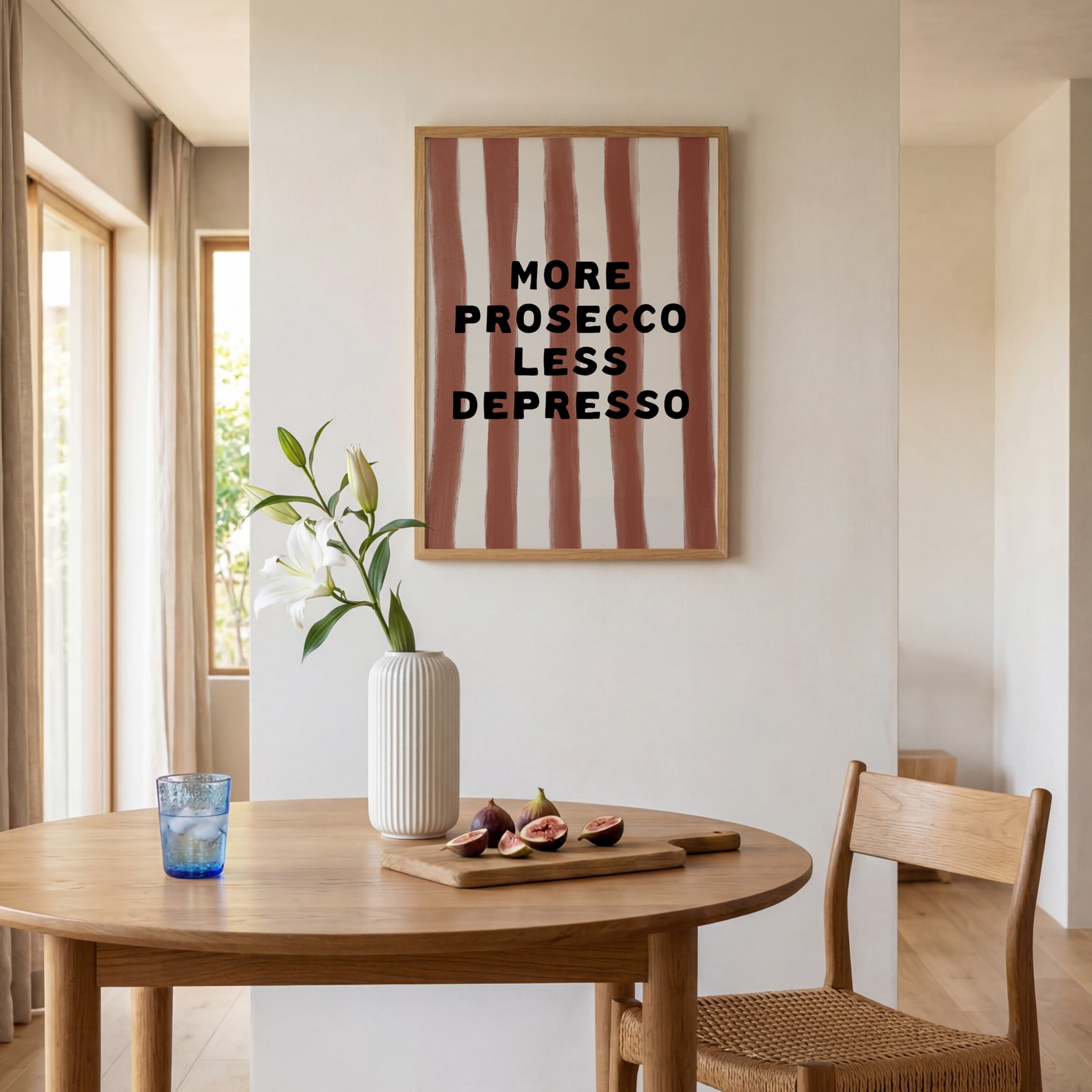 Dining room with a wooden table, chair, vase, and decorative wall art.