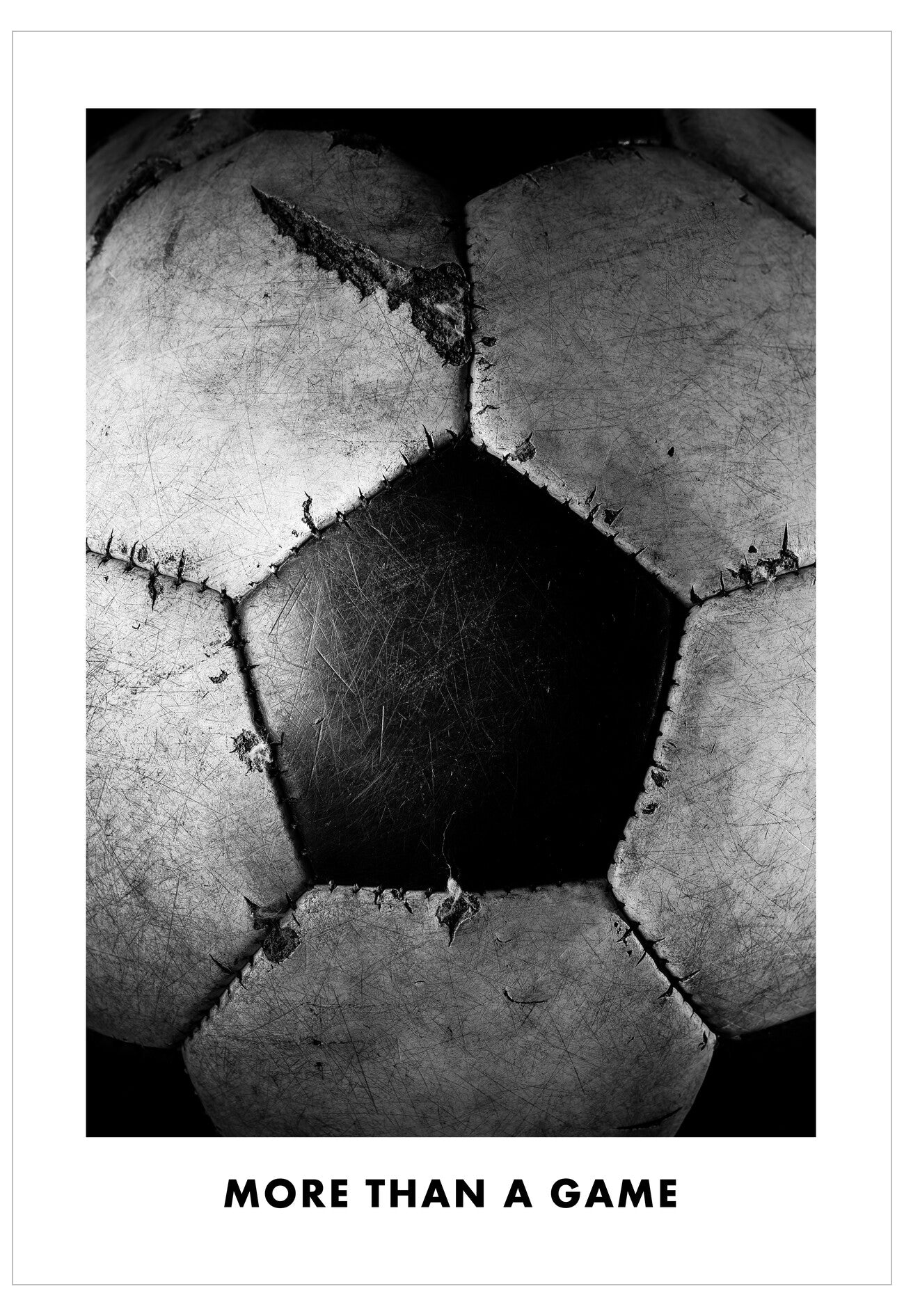 Black and white close-up of a soccer ball with text 'More than a game'.