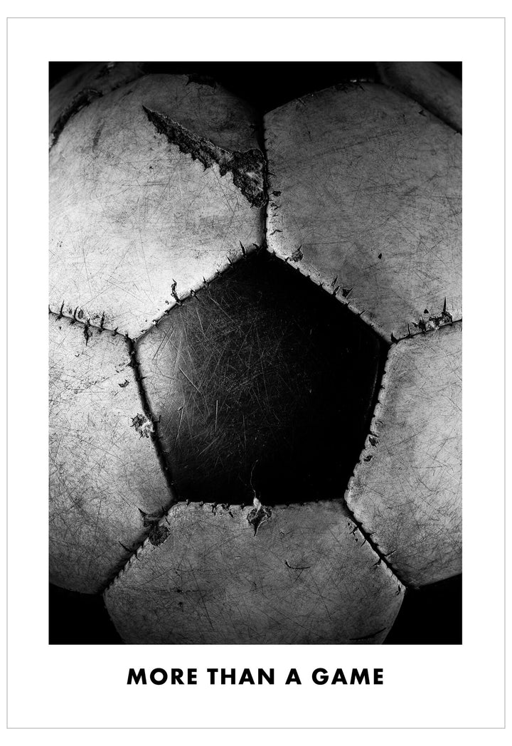 Black and white close-up of a soccer ball with text 'More than a game'.