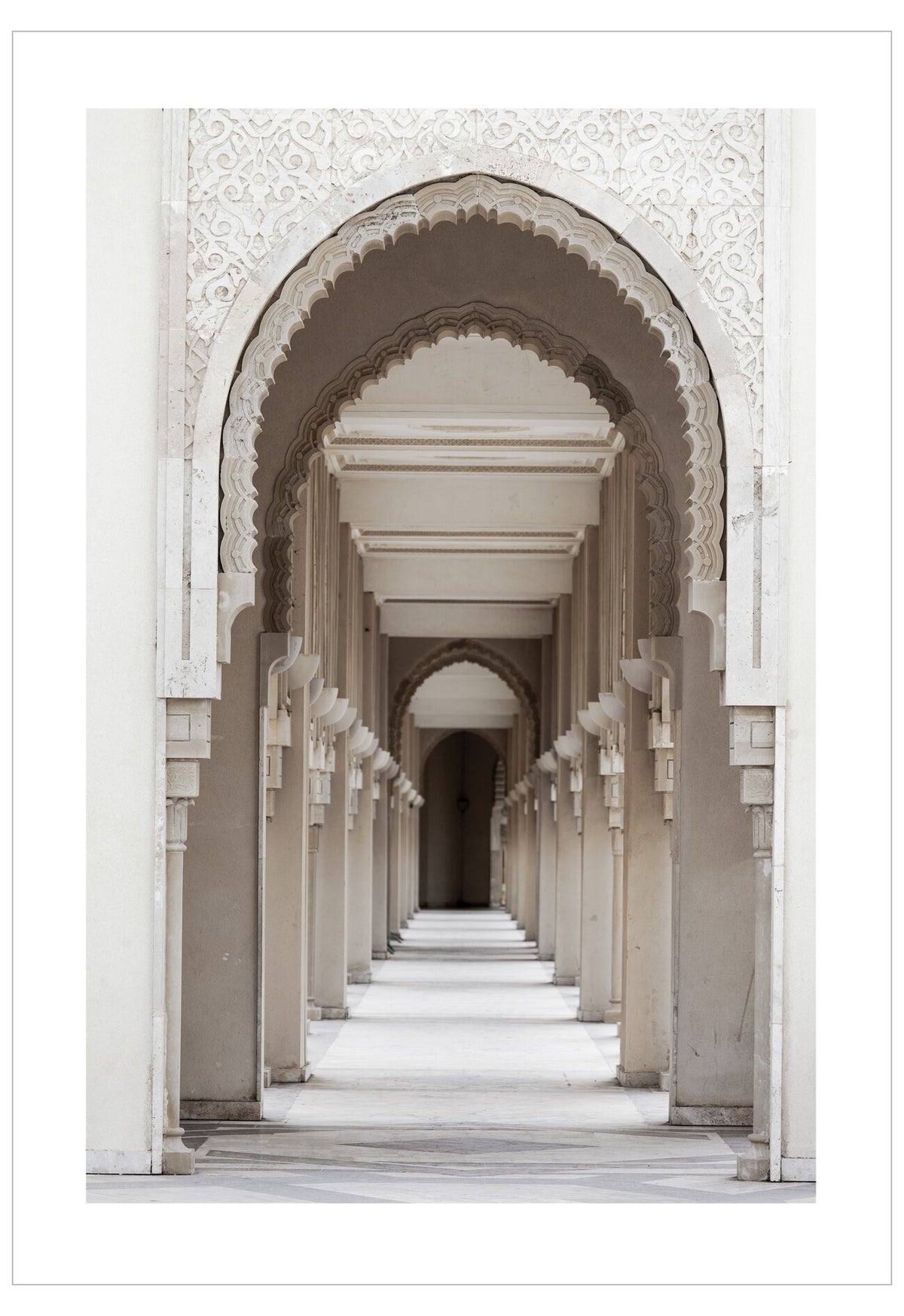 Long corridor with arched passageways and white marble floors