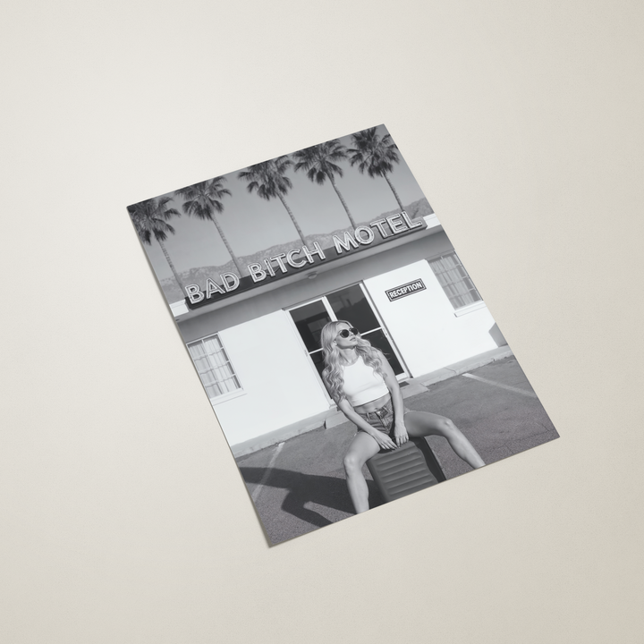 poster with a black and white photo of a building labeled 'Bad Bitch Hotel' on a beige background