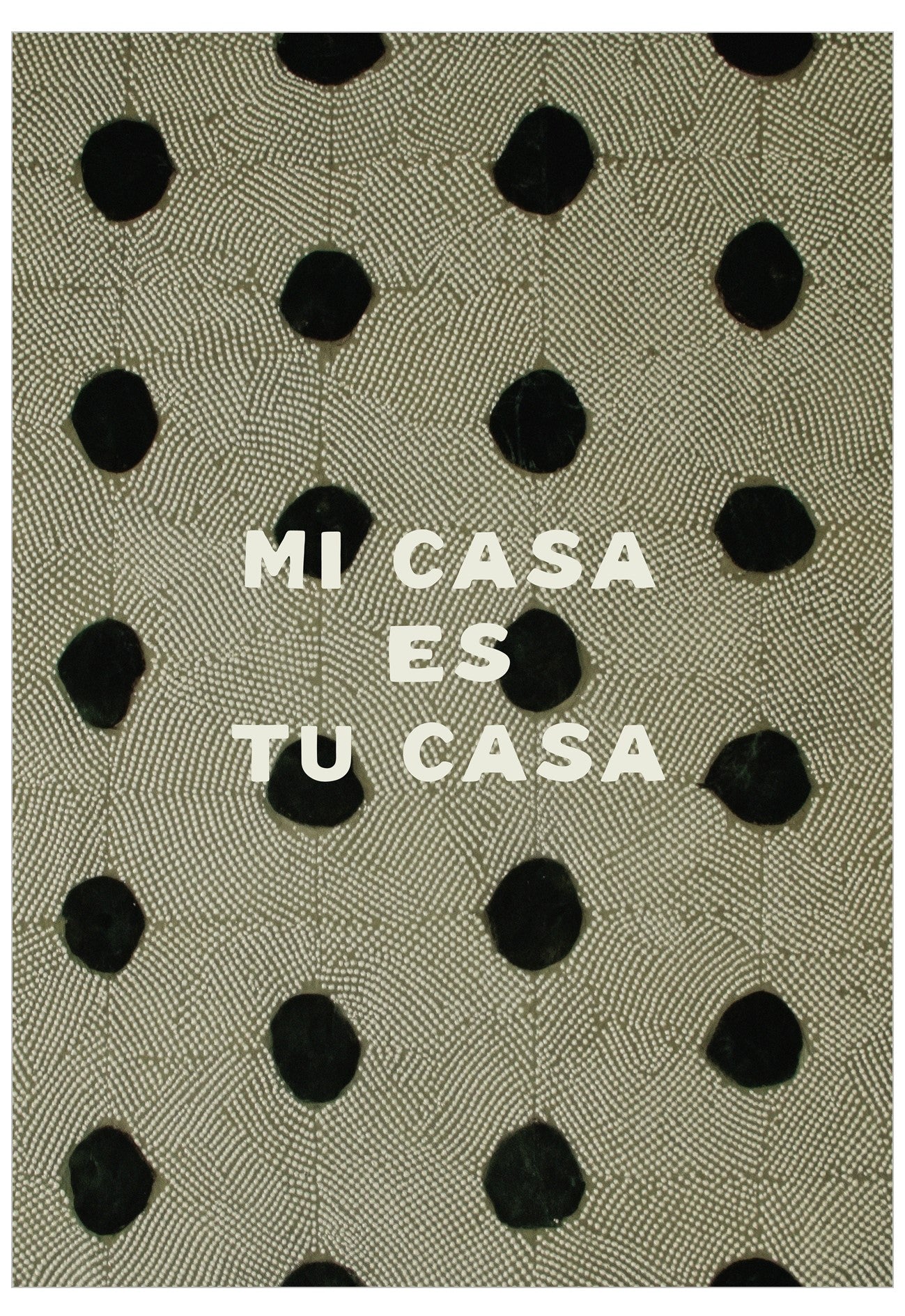 Text 'MI CASA ES TU CASA' on a patterned fabric background