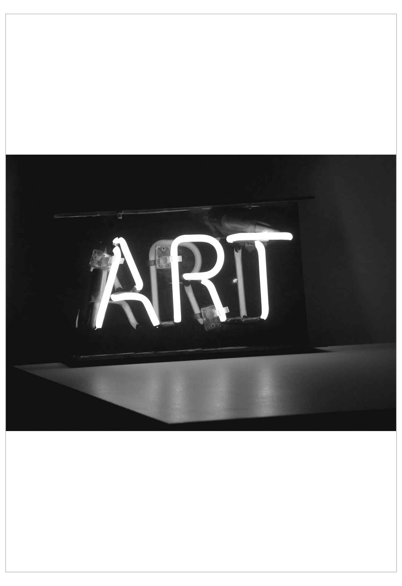 Neon sign with the word 'ART' in a dark setting