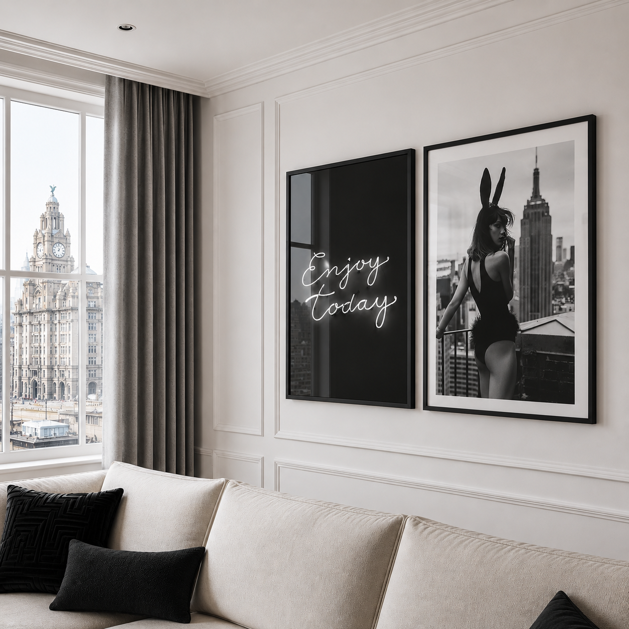 Living room with a sofa, framed art on the wall, and a window view of a cityscape.