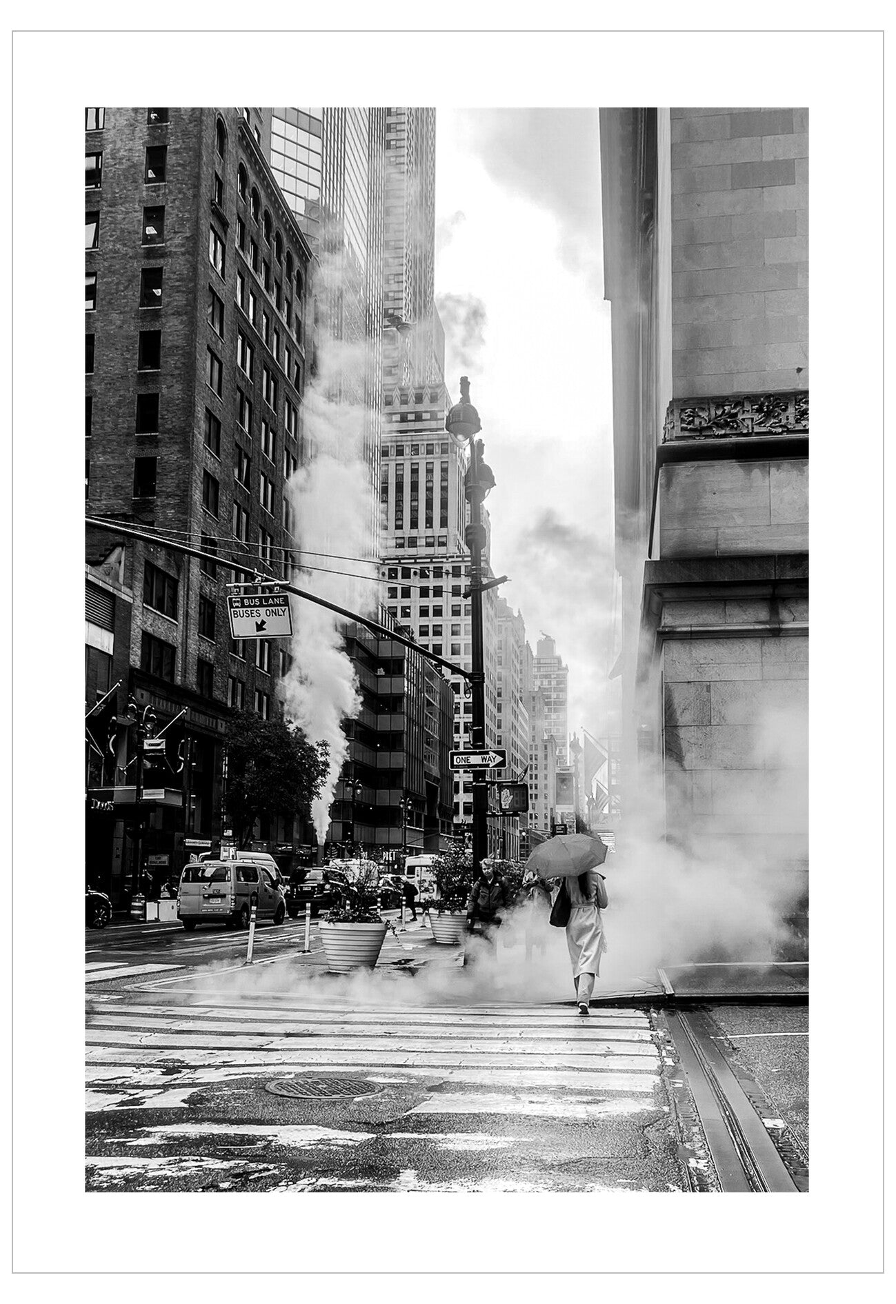 Person with an umbrella crossing a city street with steam rising from the buildings