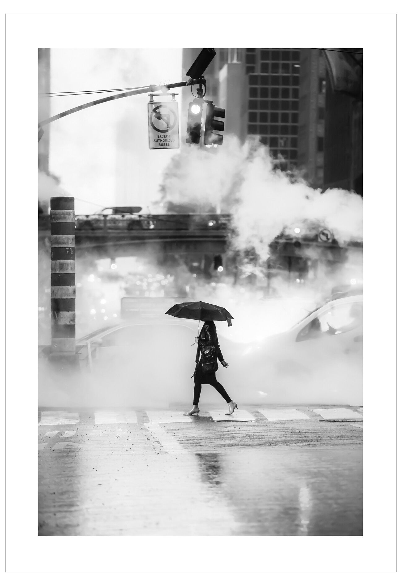 Person walking with an umbrella on a city street with steam rising