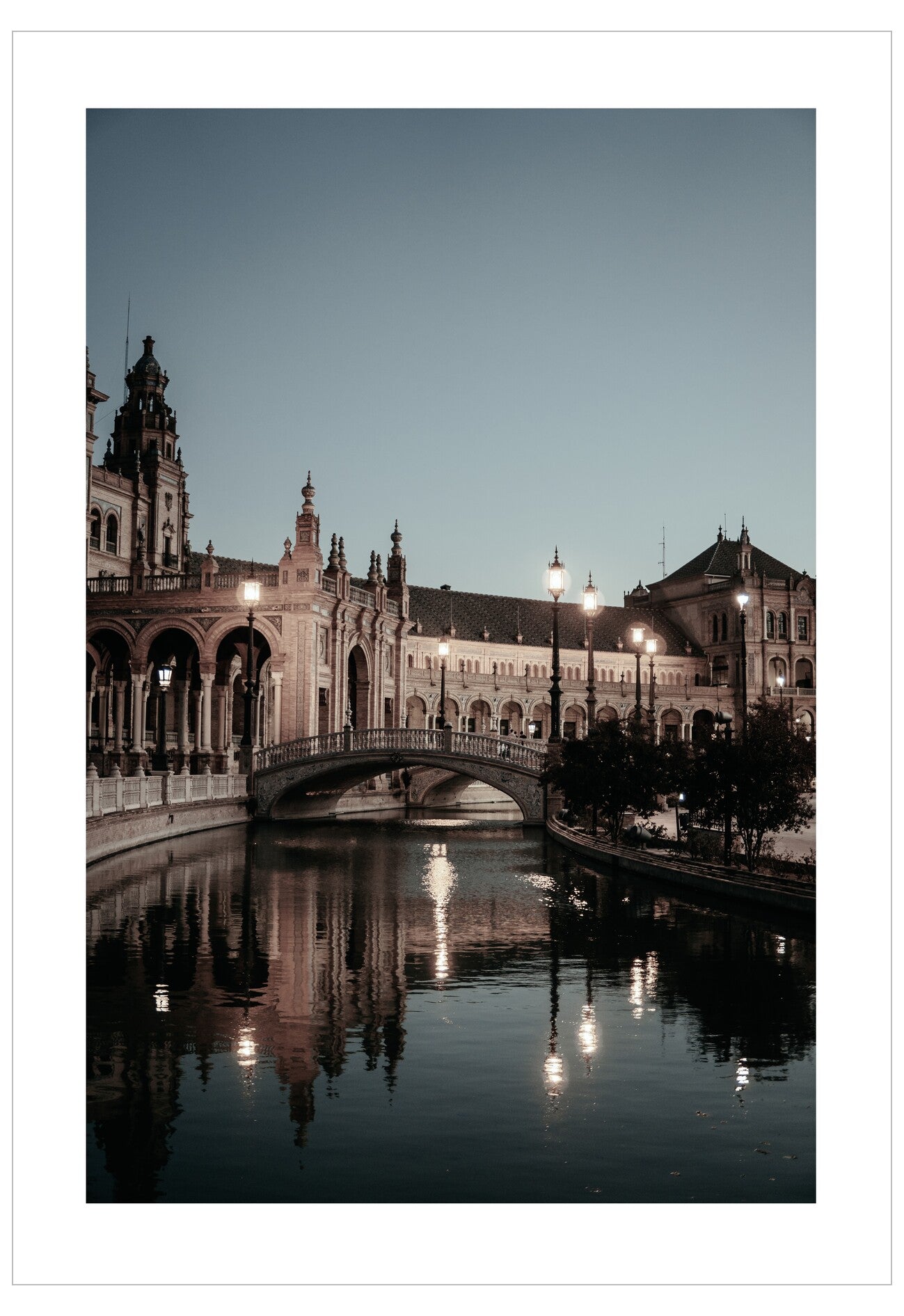 Cityscape with a bridge over a river at dusk