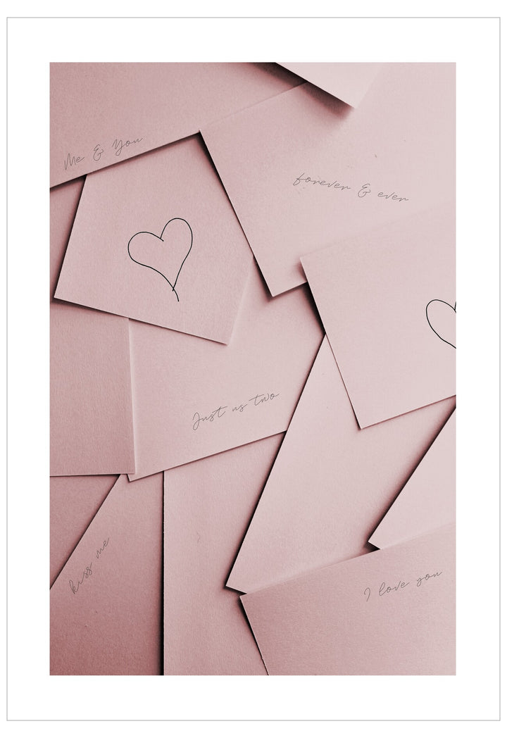 Pink cards with heart designs and text on a white background