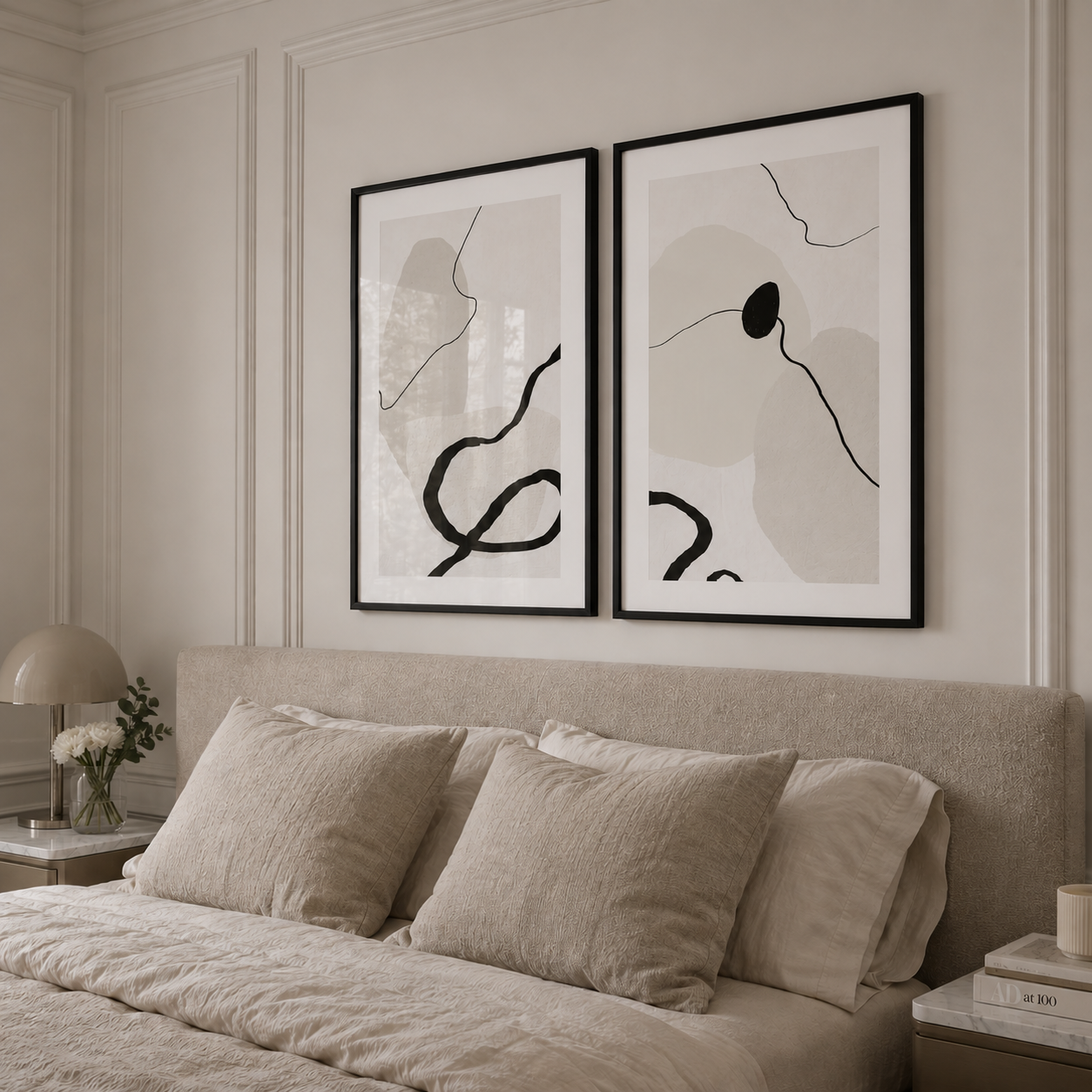 Two abstract art pieces on a wall above a bed with neutral tones.