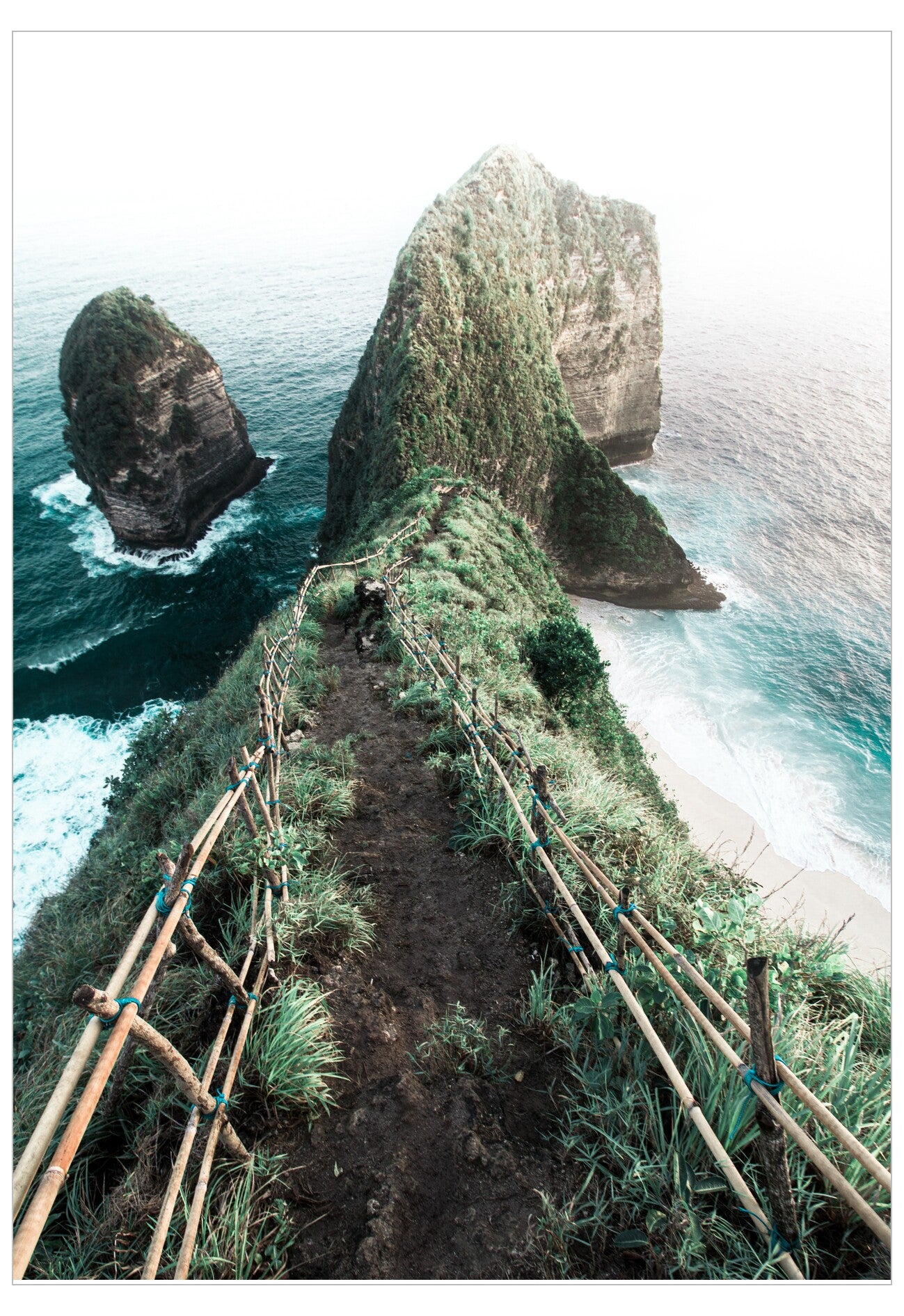 Path leading to rocky outcrops with ocean on either side