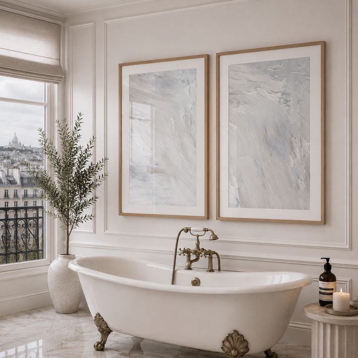 Luxurious bathroom with a freestanding bathtub, framed artwork, and decorative elements.