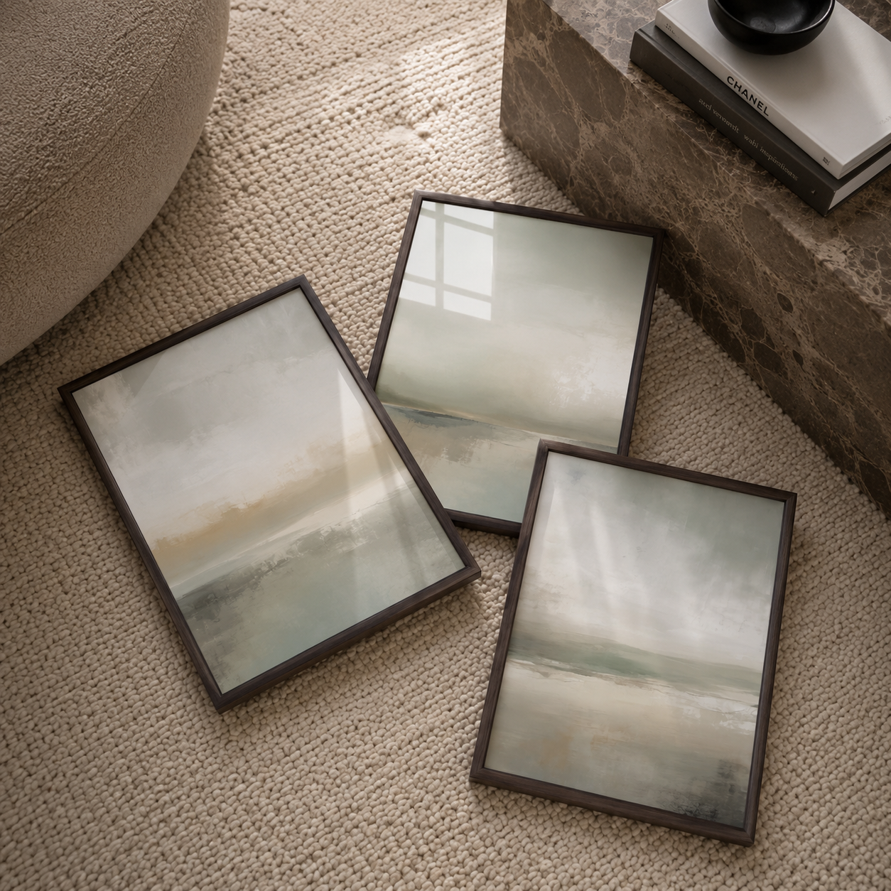 Three olive green framed artworks on a textured surface