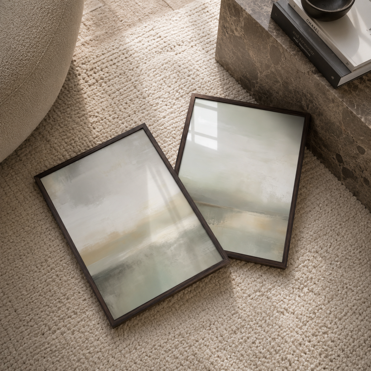 Two olive green framed artworks on a textured surface