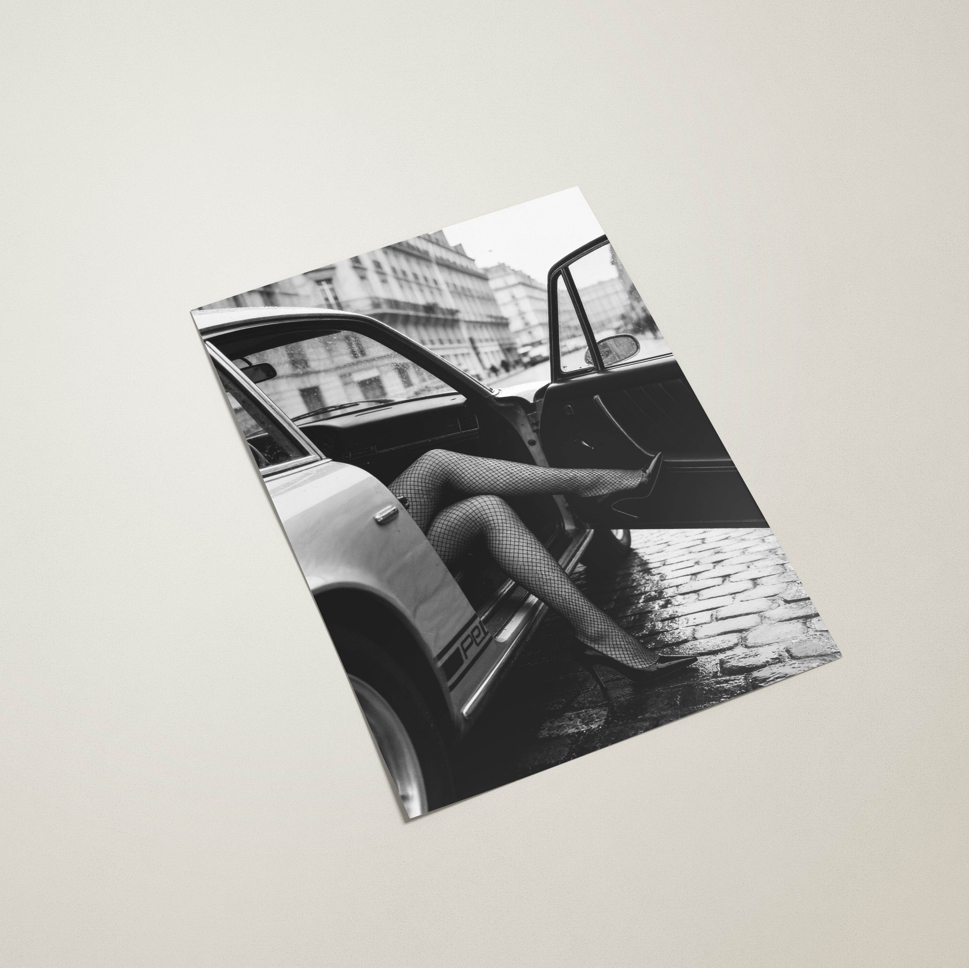 Black and white poster with a car and person on the cover on a beige background