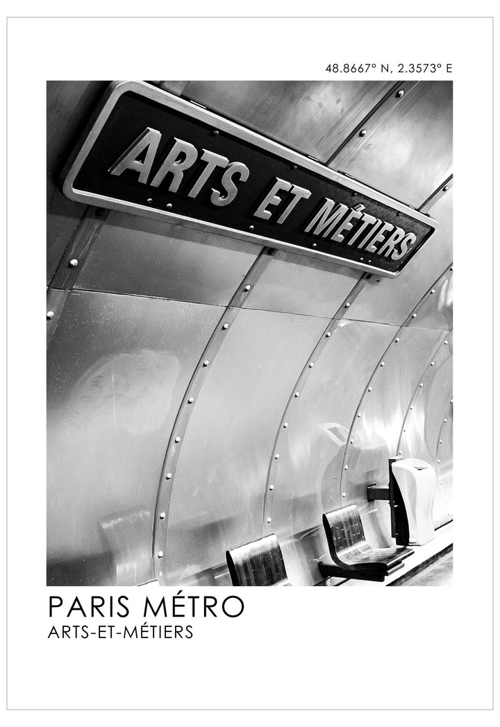 Black and white photo of a metro sign reading 'ARTS ET MéTIERS' in Paris, France.