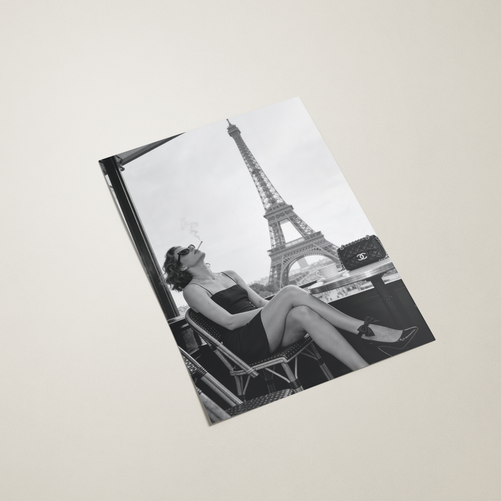 Poster featuring a black and white photo of a woman and the Eiffel Tower on a beige background
