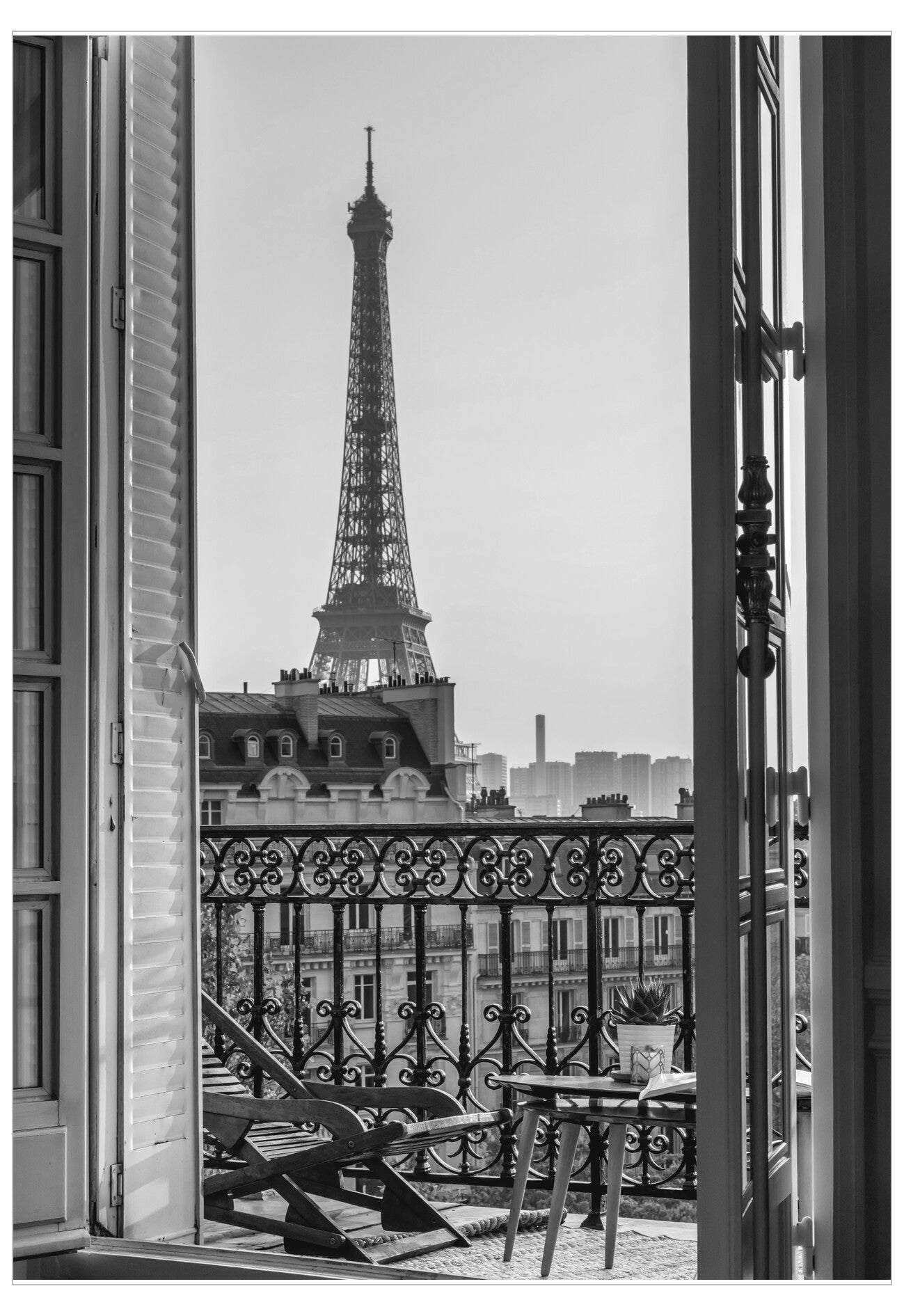 View of the Eiffel Tower from a balcony with an open door.