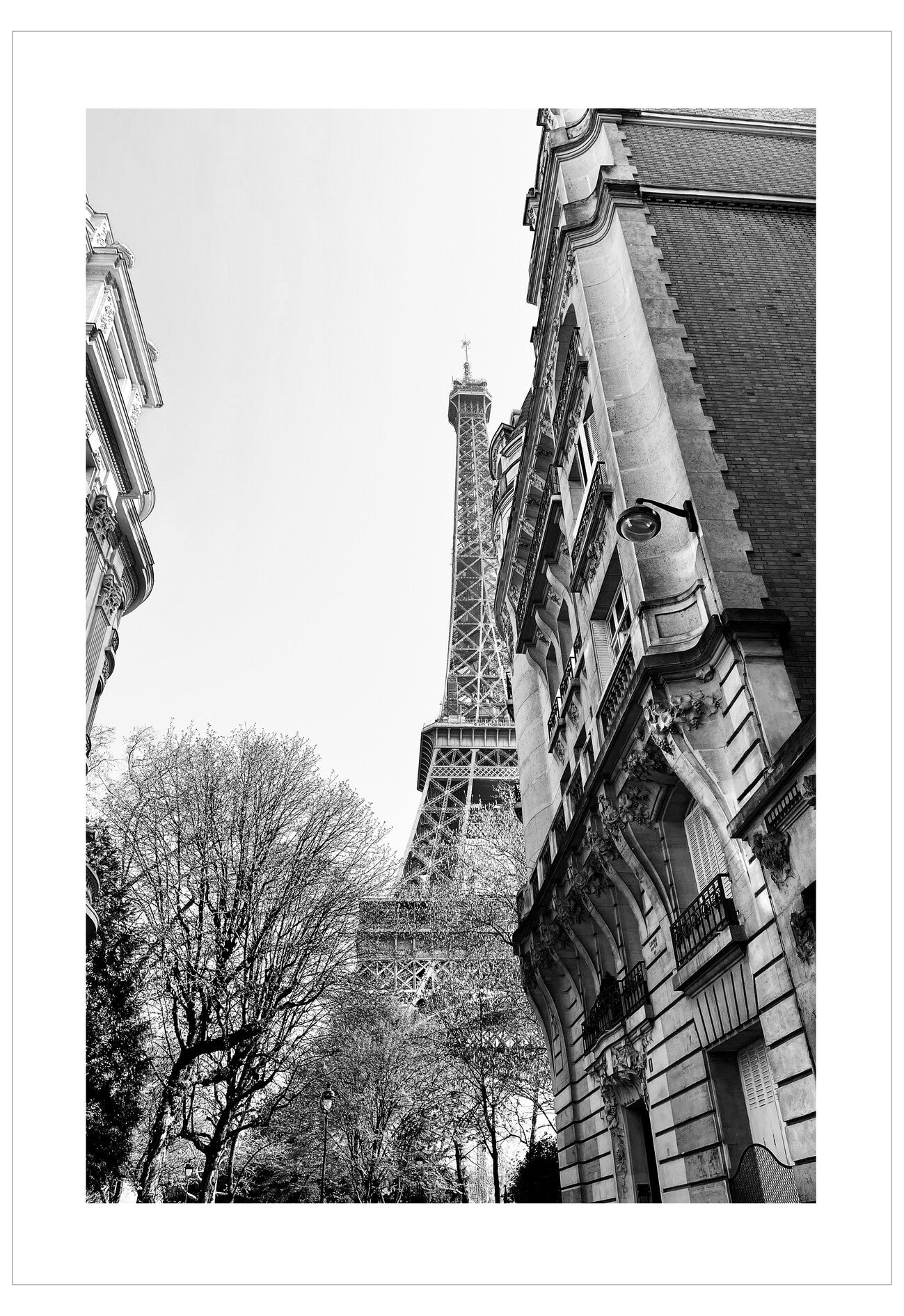 Black and white photo of the Eiffel Tower with architectural details in the foreground
