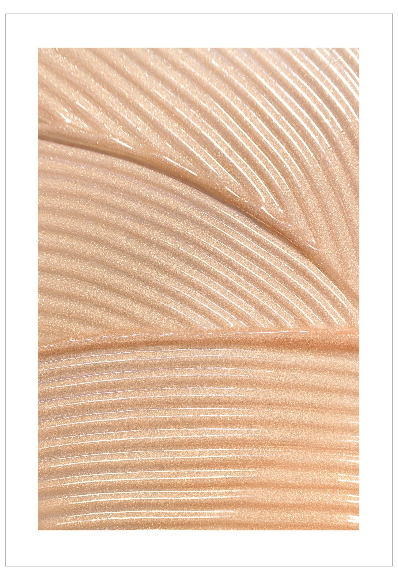 Close-up of beige cream with wavy texture on a white background