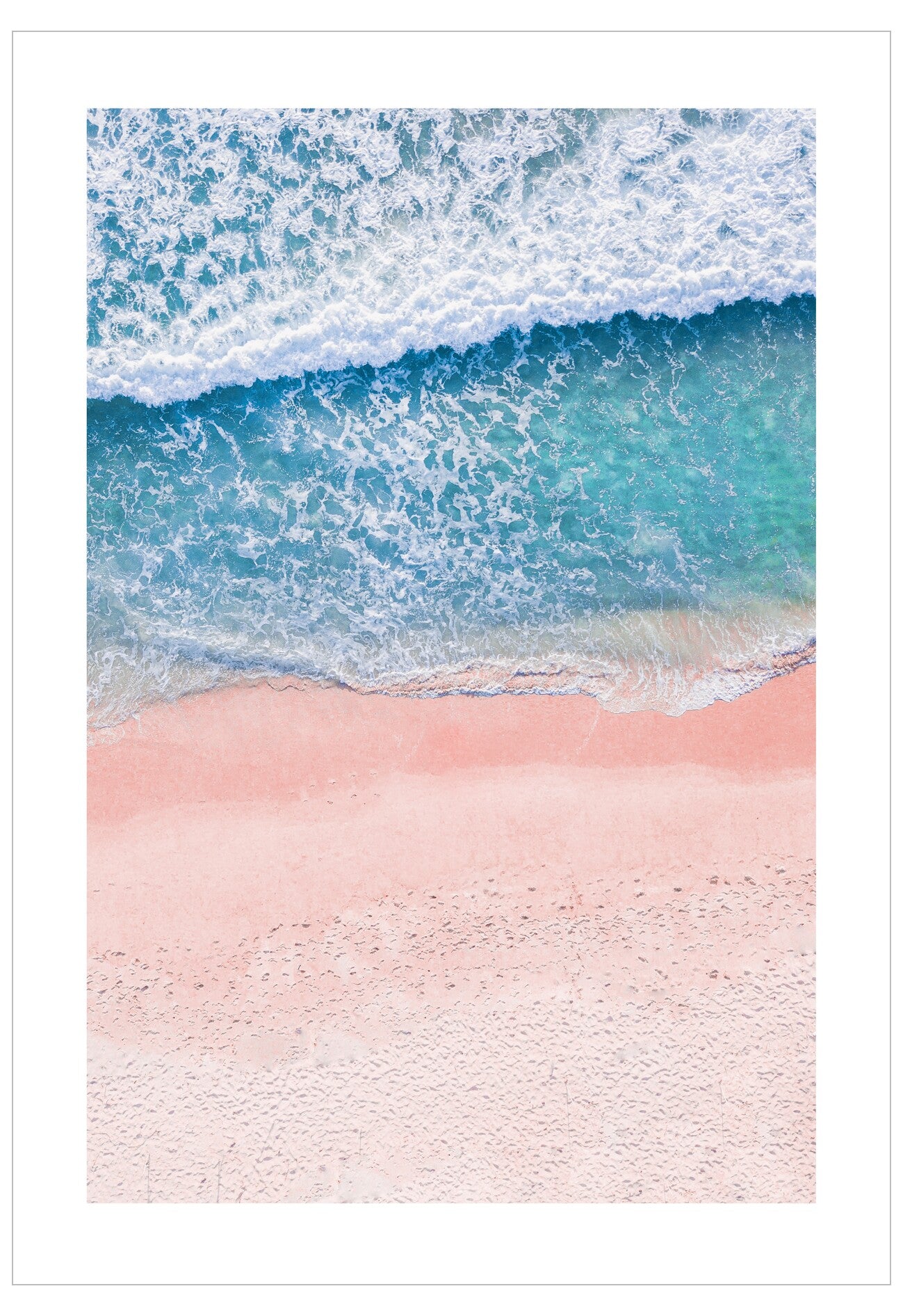 Blue ocean waves crashing onto a pink sandy beach