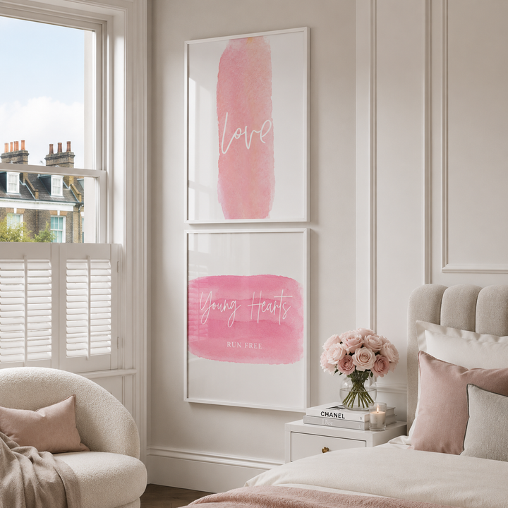 Decorative bedroom with pink wall art and a vase of flowers on a nightstand.
