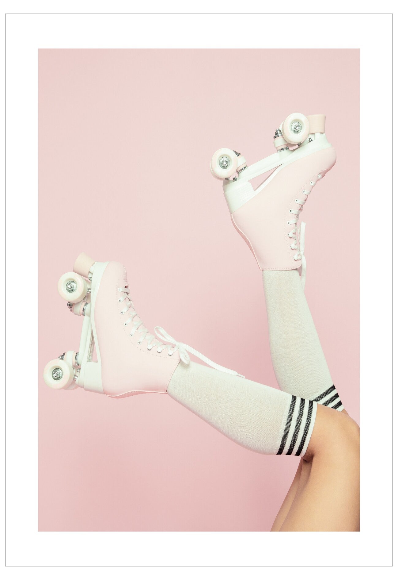 White roller skates with black stripes on a pink background
